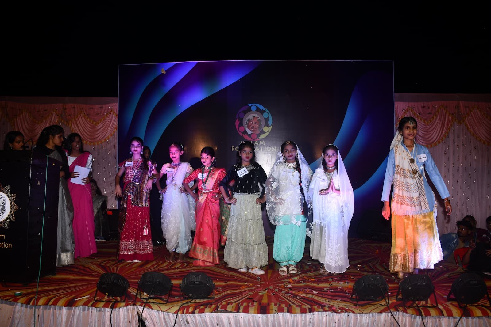 Children in traditional dress from different states on stage